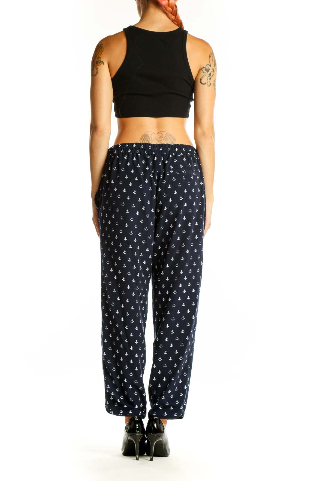Side view of model wearing J.Crew navy anchor print pants with black top