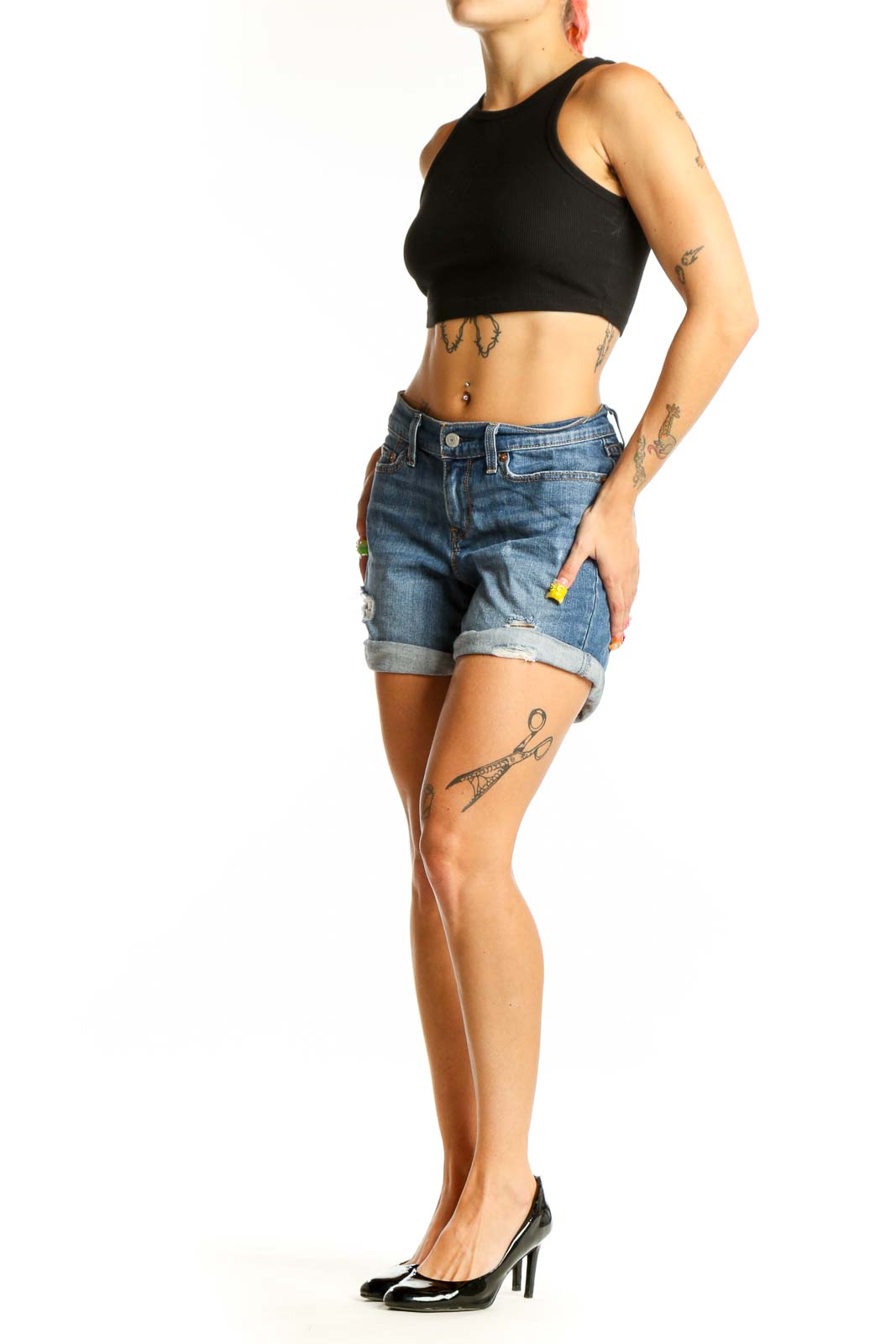 Front view of blue distressed Levi's denim shorts with rolled cuffs