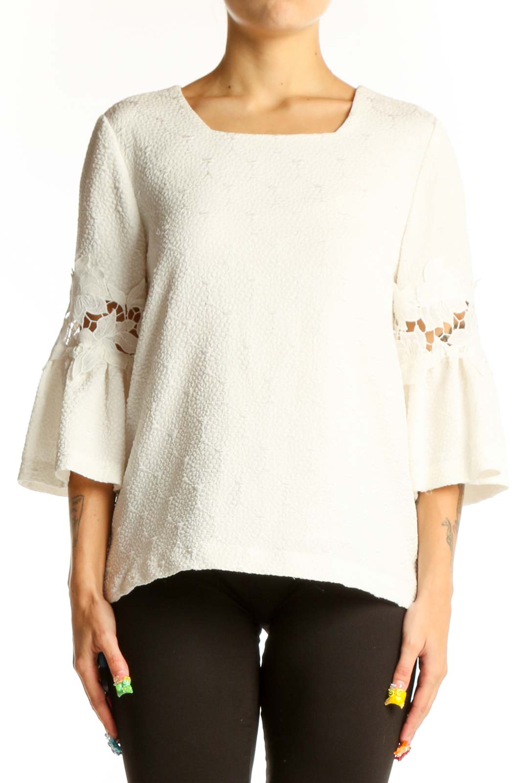 Front view of white Calvin Klein blouse with textured fabric and bell sleeves