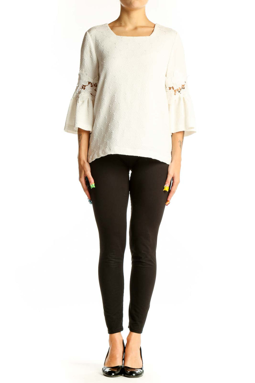 Front view of white Calvin Klein blouse with textured fabric and bell sleeves