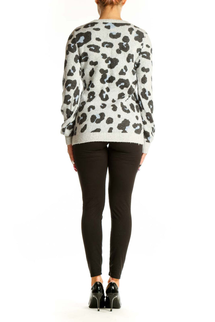Side view of LOFT gray leopard print knit sweater on model with black pants