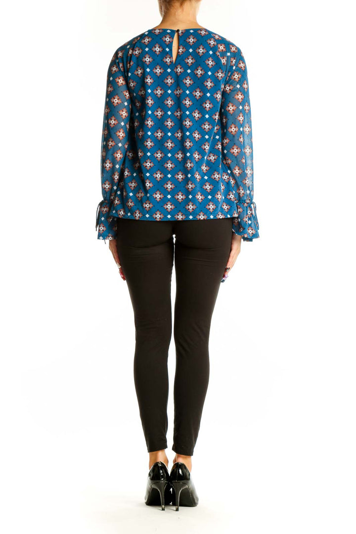 Back view of 41 Hawthorn blue floral print blouse showing relaxed fit and hip-length hem