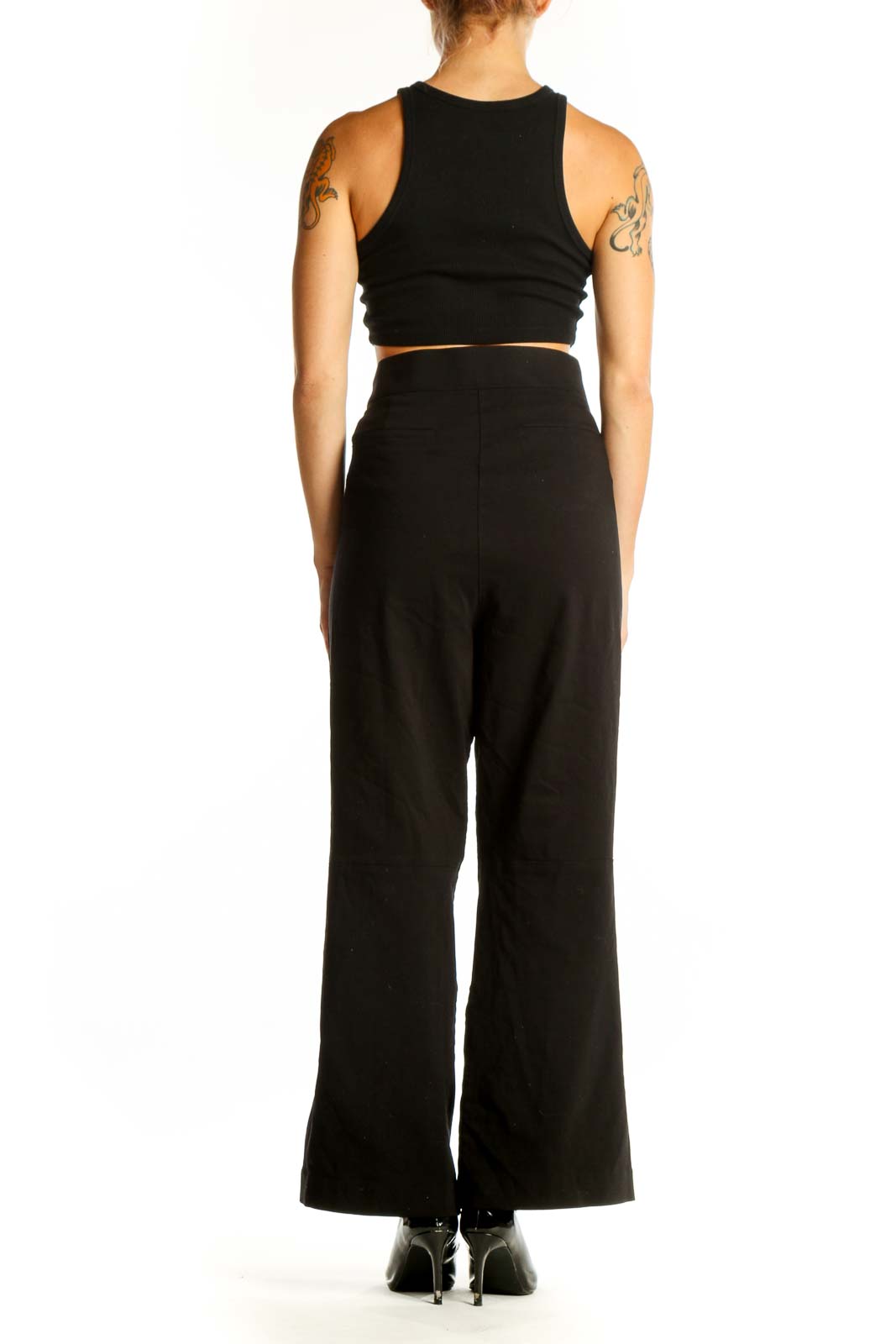 Side view of Calvin Klein black wide-leg trousers with crop top