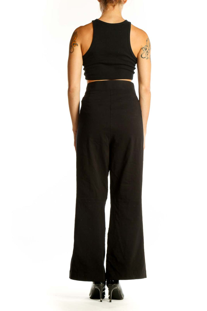 Side view of Calvin Klein black wide-leg trousers with crop top