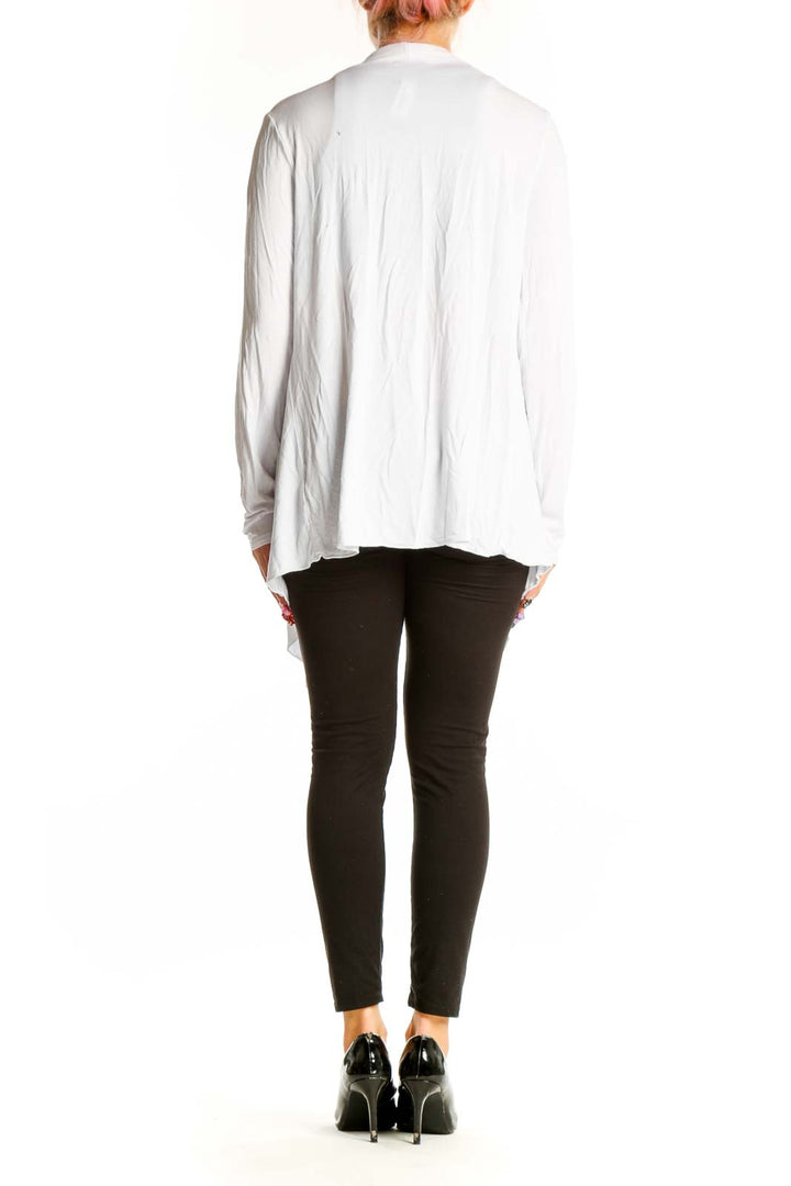 Side view of white draped open front cardigan by URBAN COCO on model