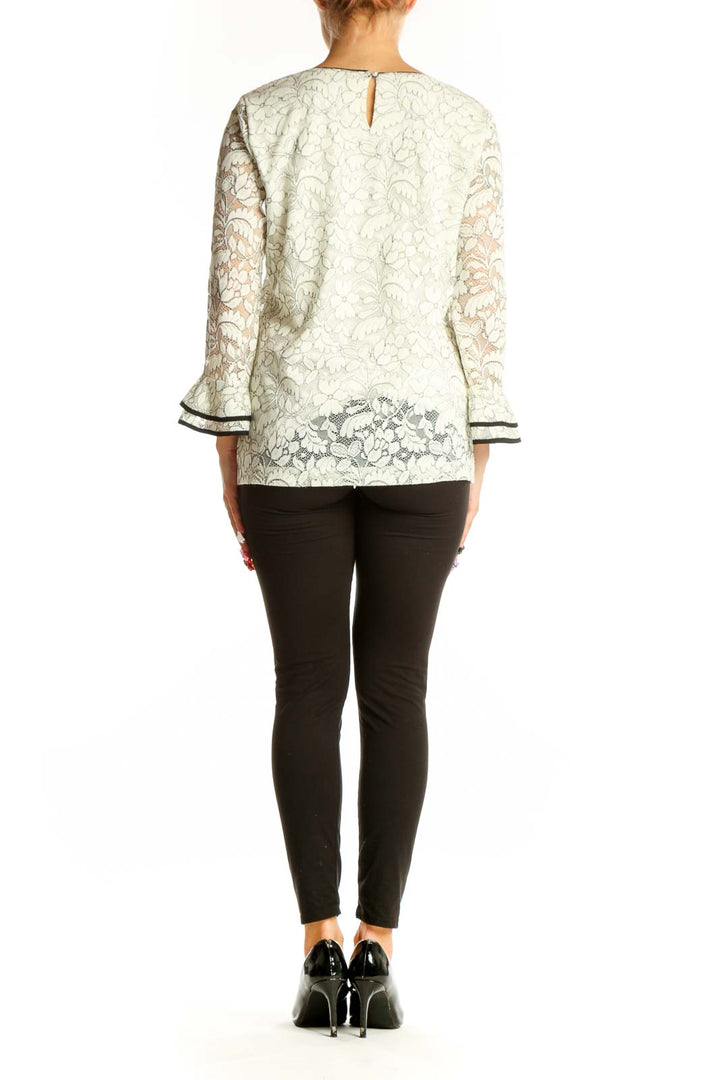 Side view of Karl Lagerfeld white lace top showing bell sleeve detail