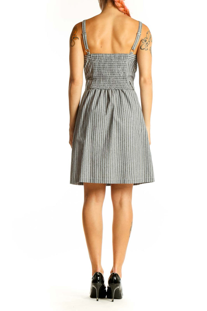 Side view of gray striped cotton sundress showing flattering silhouette