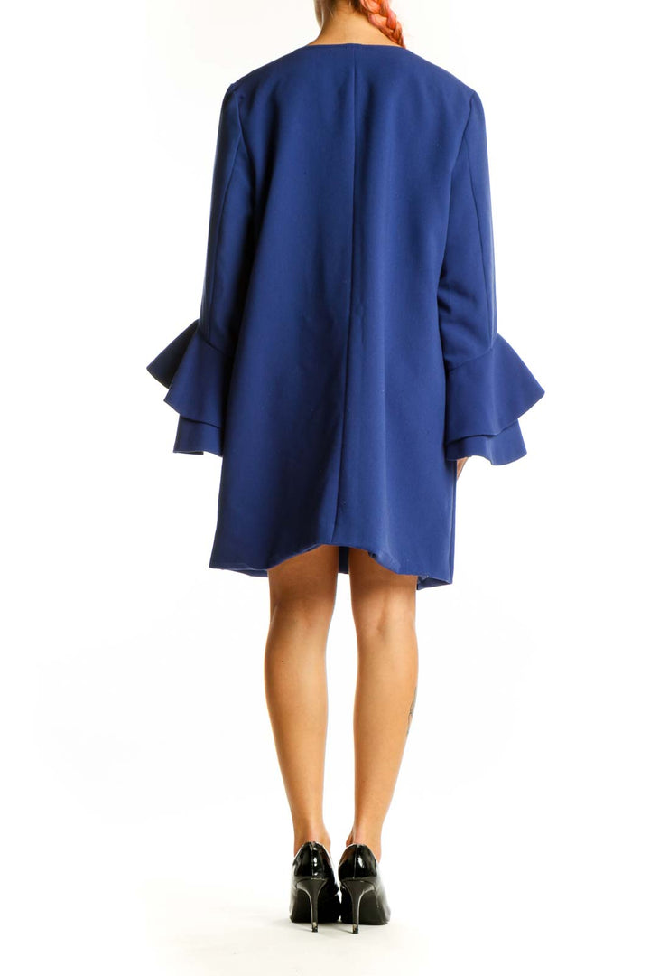 Side view of blue Alfani dress showing ruffle sleeve detail and A-line silhouette