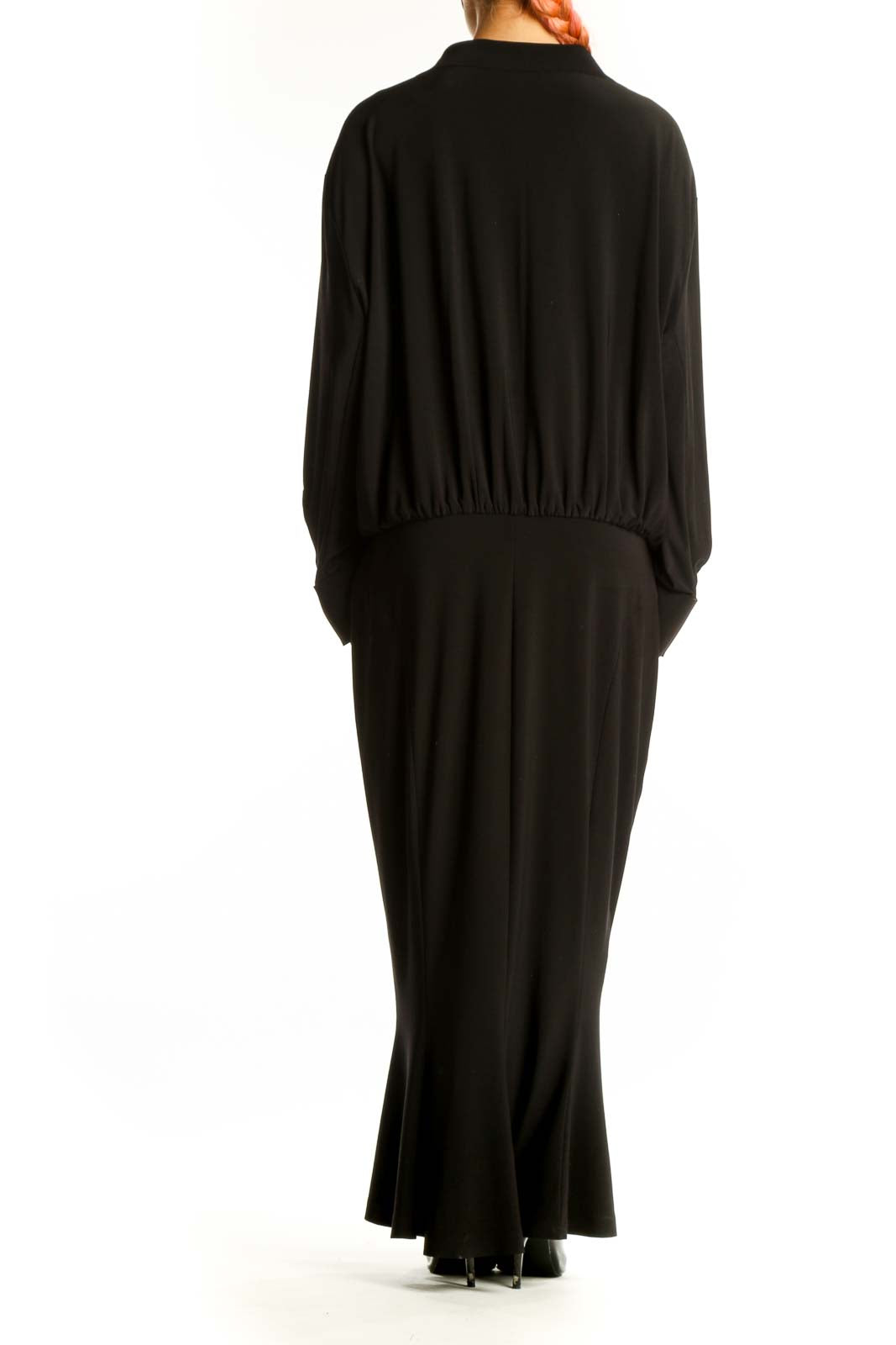 Side view of black NORMA KAMALI long-sleeve maxi dress showing full length