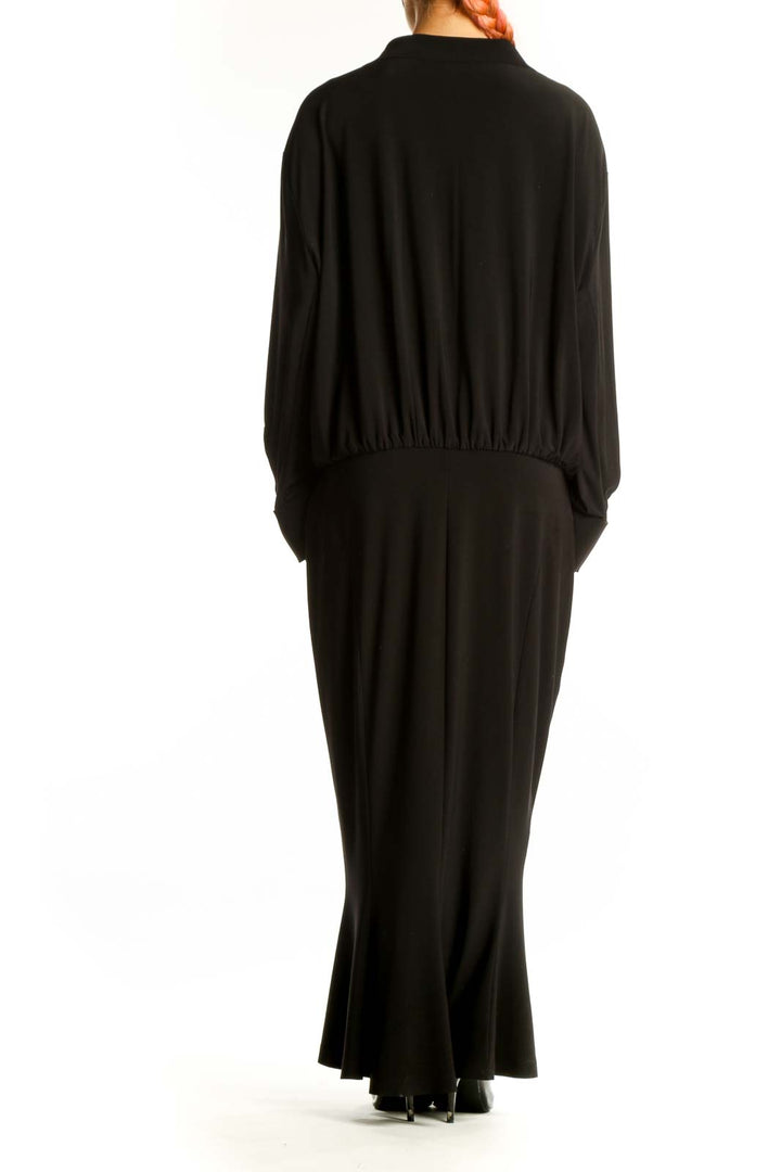 Side view of black NORMA KAMALI long-sleeve maxi dress showing full length