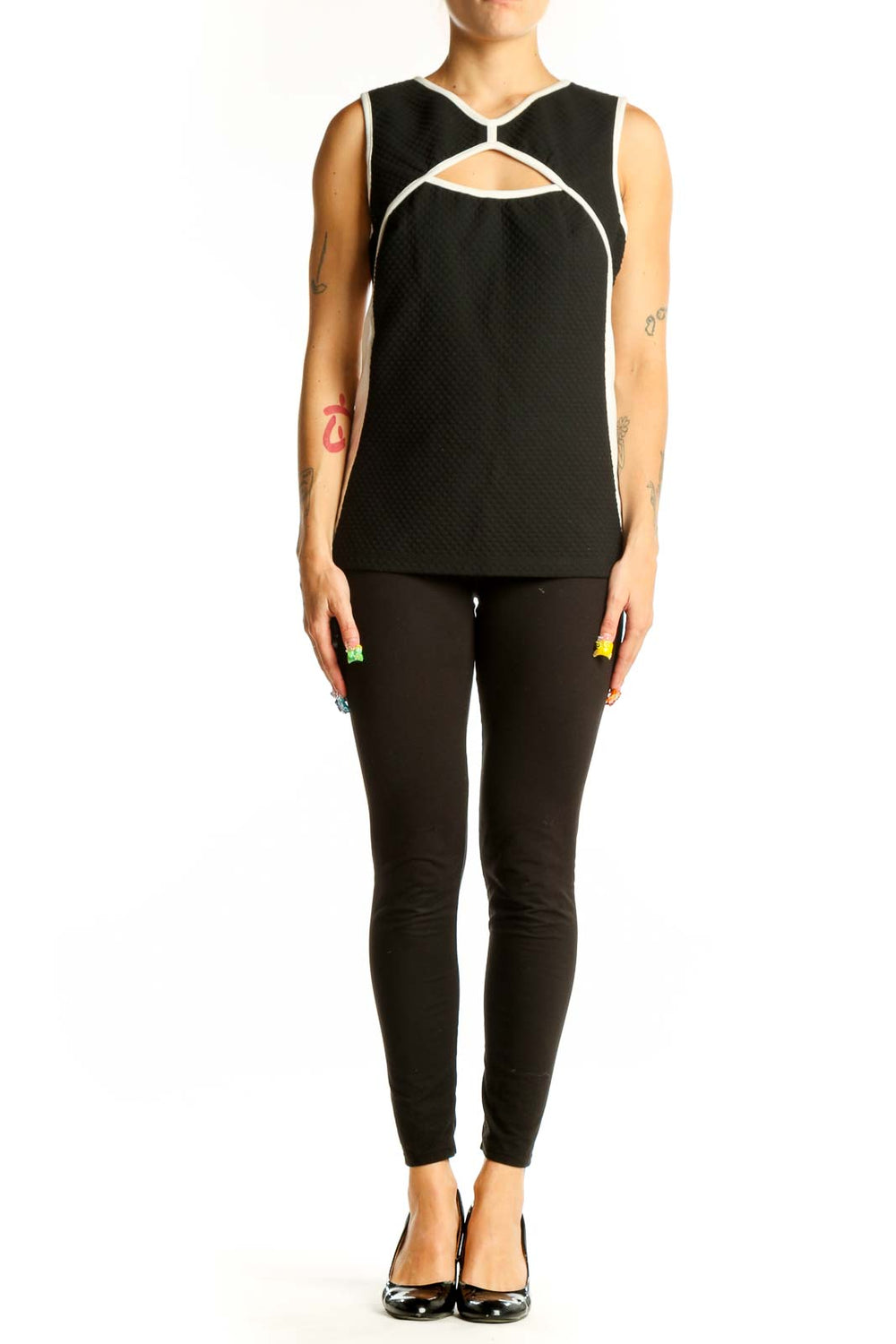 Front view of Bailey 44 black sleeveless top with cutout design and white trim