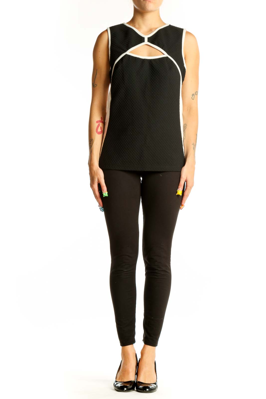 Front view of Bailey 44 black sleeveless top with cutout design and white trim
