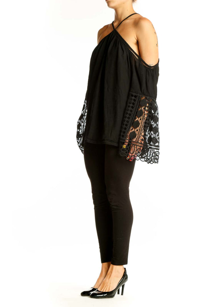 Front view of Ramy Brook black cold shoulder blouse with lace-trimmed bell sleeves