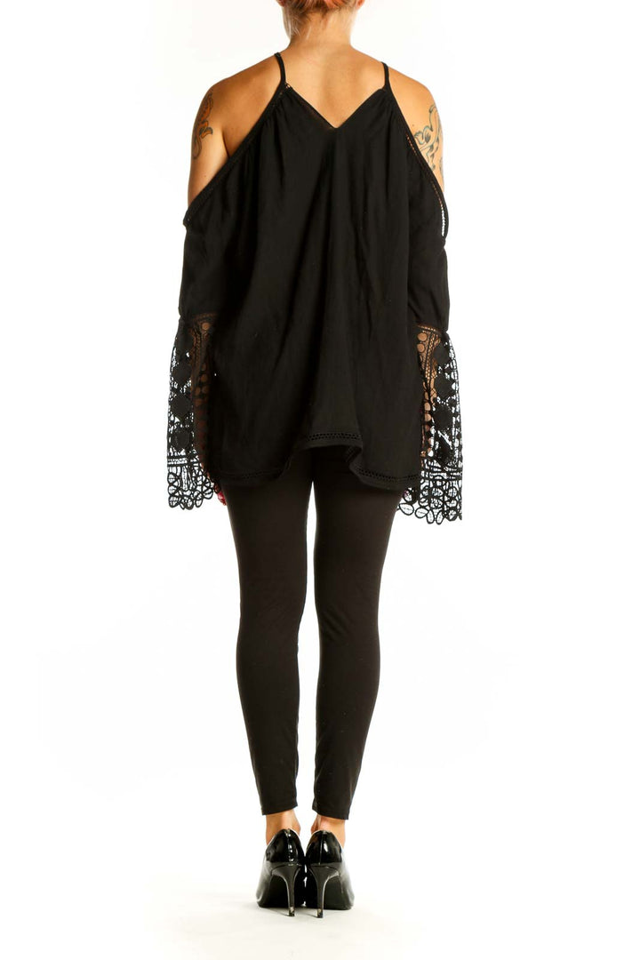 Side view of Ramy Brook black cold shoulder blouse showing lace sleeve detail