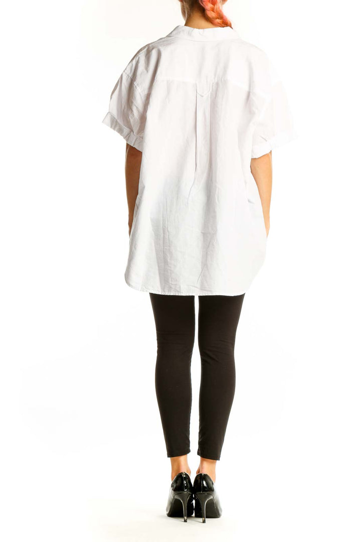 Side view of Madewell white oversized button-down shirt on model with black pants