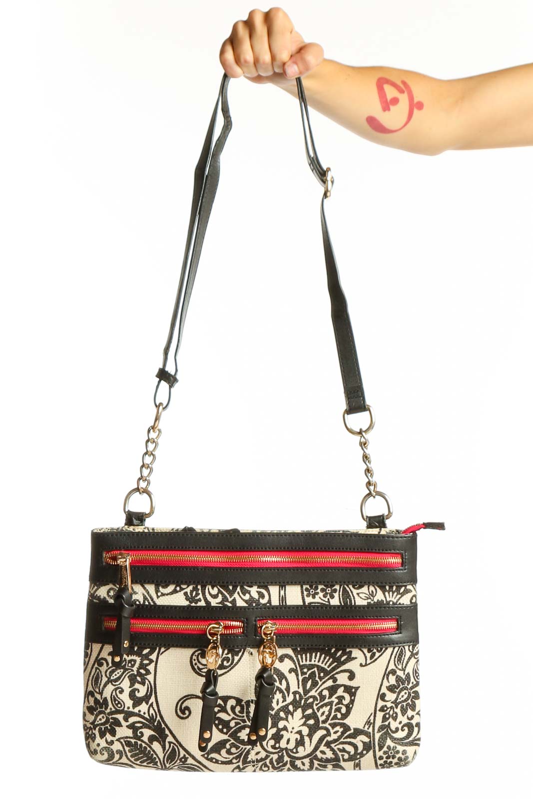 Front view of Spartina 449 black and white floral crossbody bag with red zipper accents