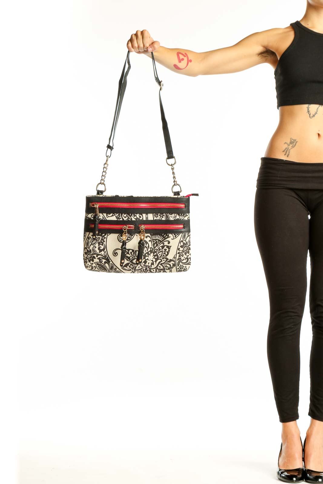 Front view of Spartina 449 black and white floral crossbody bag with red zipper accents