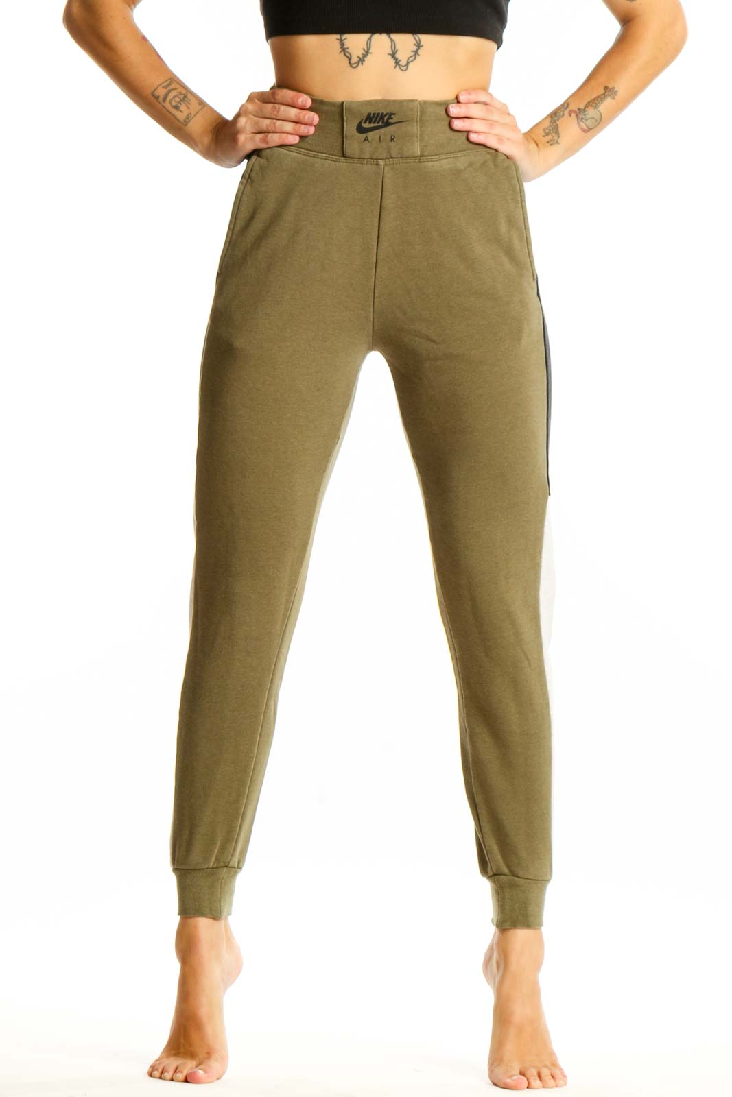 Front view of olive green Nike jogger pants with colorblock design