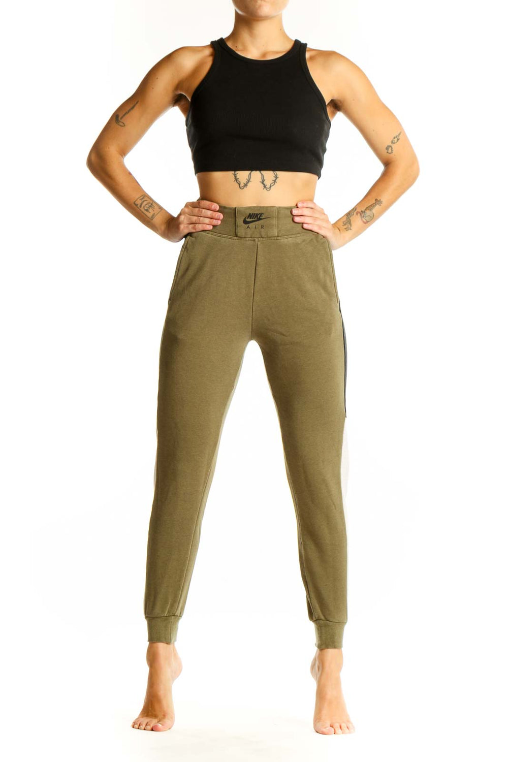 Front view of olive green Nike jogger pants with colorblock design