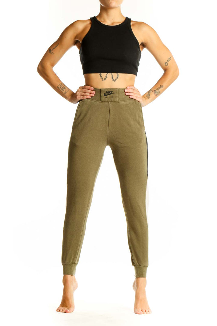 Front view of olive green Nike jogger pants with colorblock design