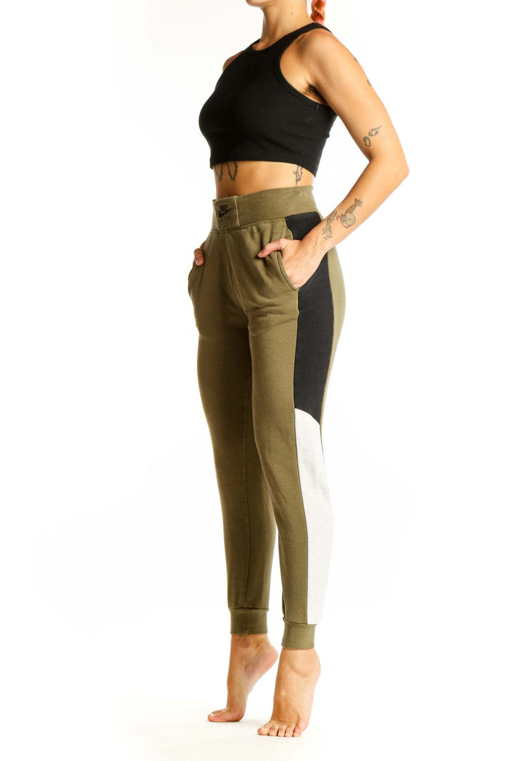 Front view of olive green Nike jogger pants with colorblock design