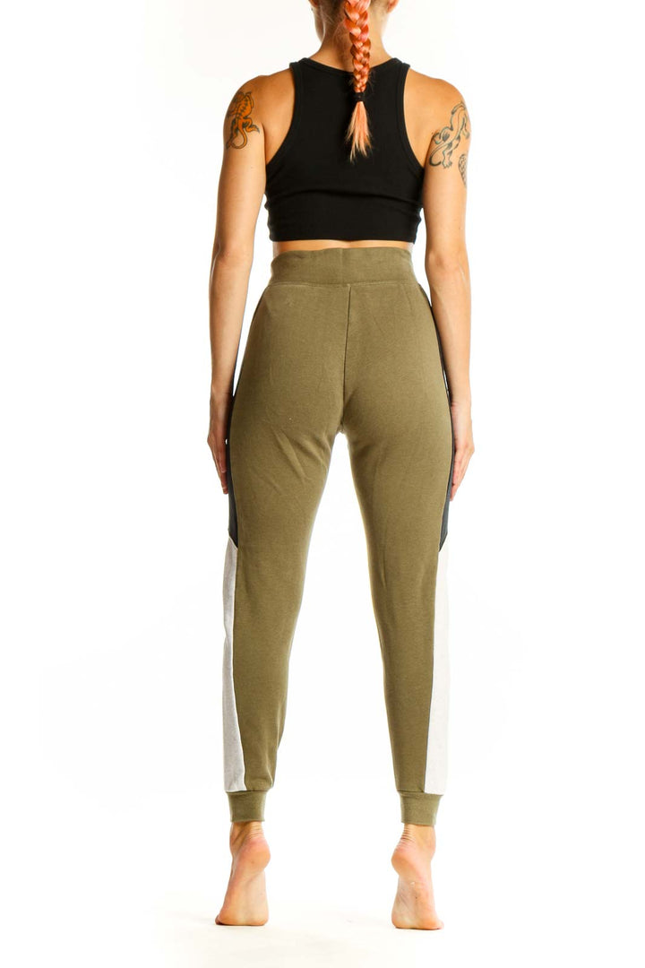 Side view of olive green Nike jogger pants showing colorblock panels