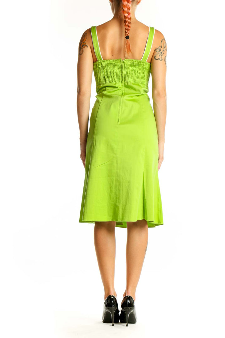 Side view of lime green sleeveless midi dress showing A-line silhouette