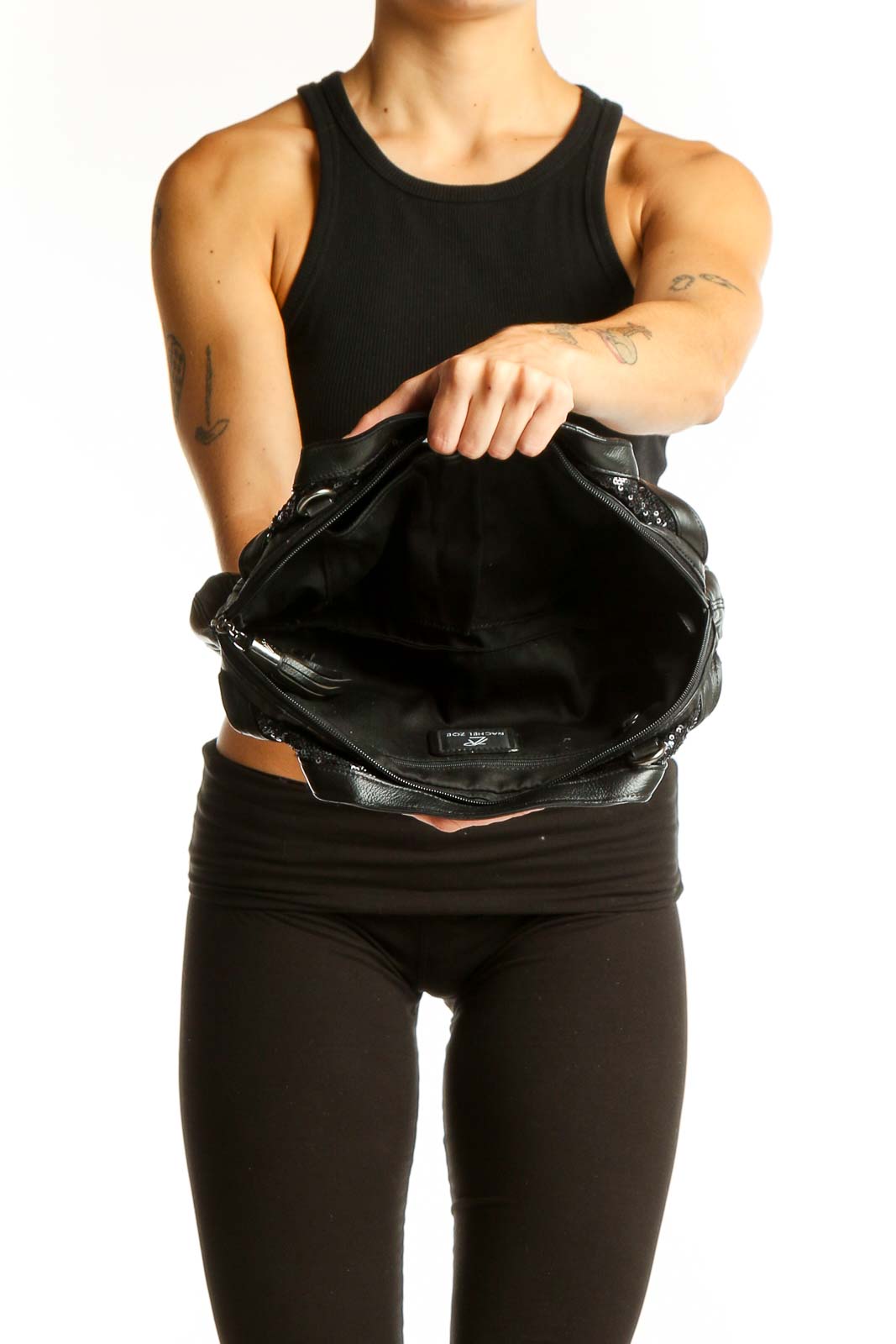 Side view of Rachel Zoe black sequined clutch worn by model
