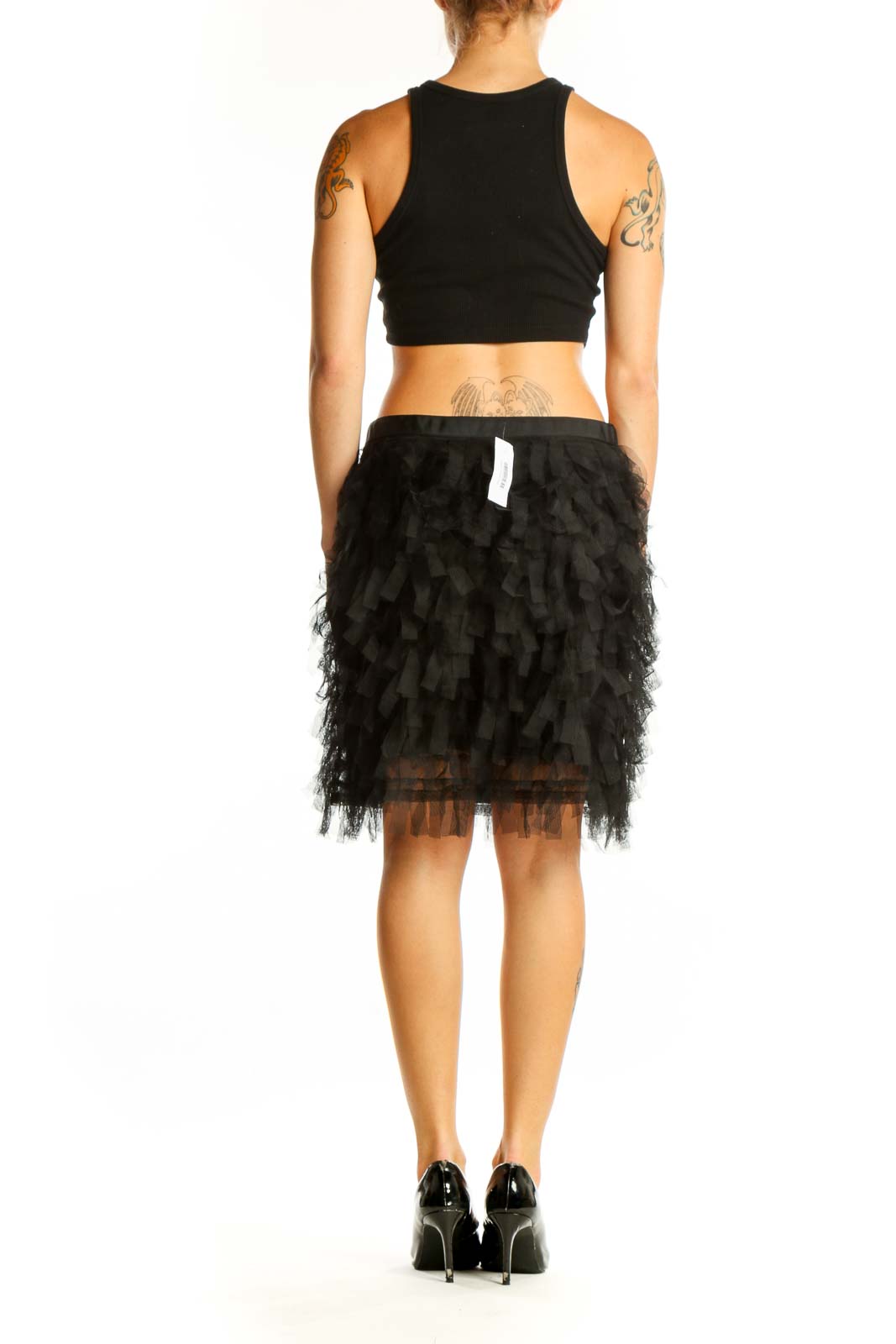 Side view of model wearing black ruffled tulle mini skirt from LOFT