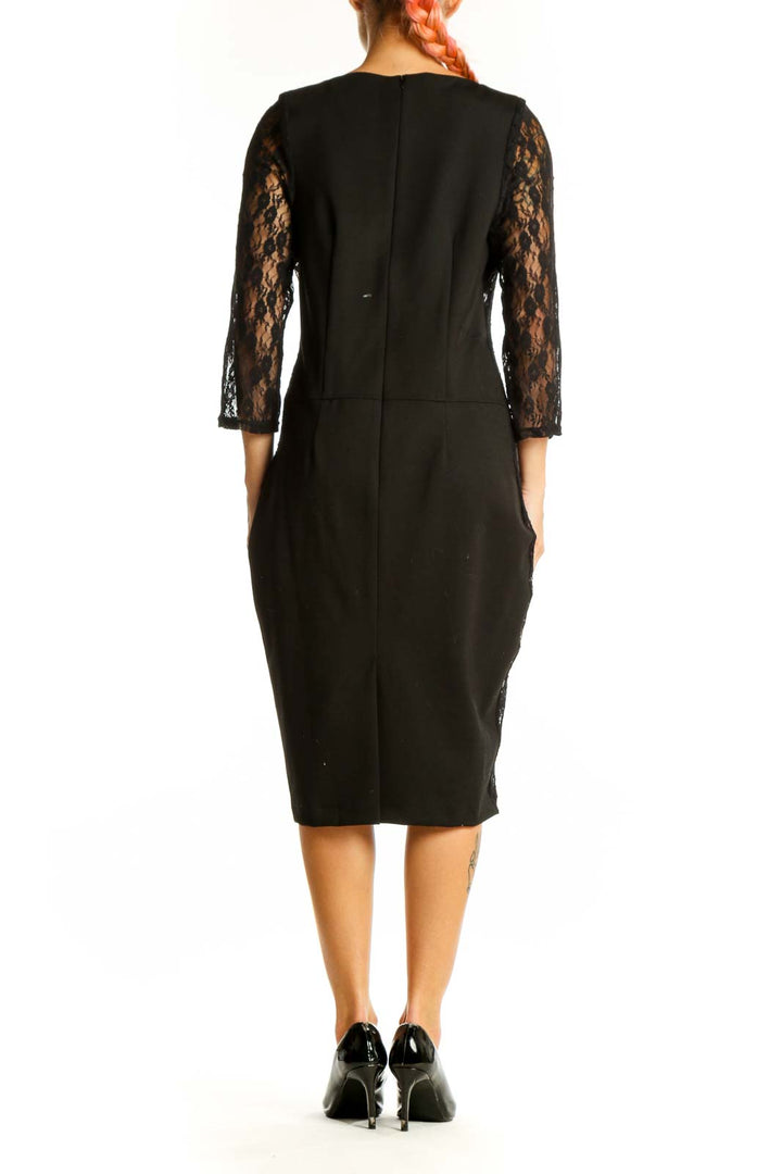 Side view of black leather midi dress with lace sleeves by Wheels & Dollbaby