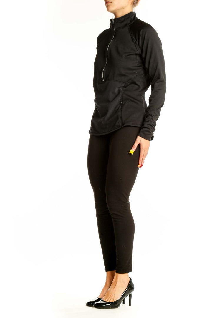 Front view of black Athleta half-zip performance top with stand-up collar