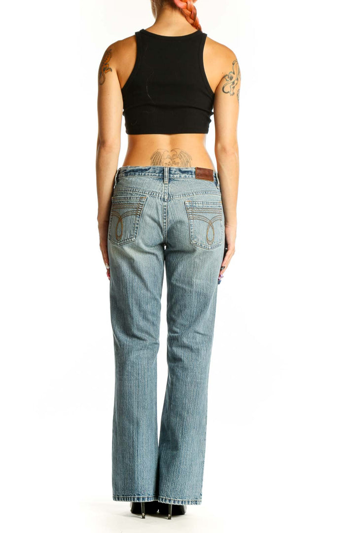 Side view of Calvin Klein light blue straight leg jeans on model with black crop top