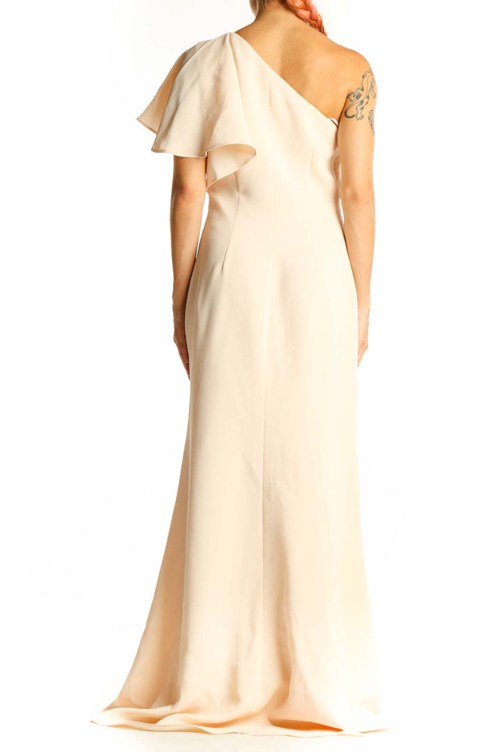 Side view of cream Vince Camuto one-shoulder maxi dress showing flowing silhouette