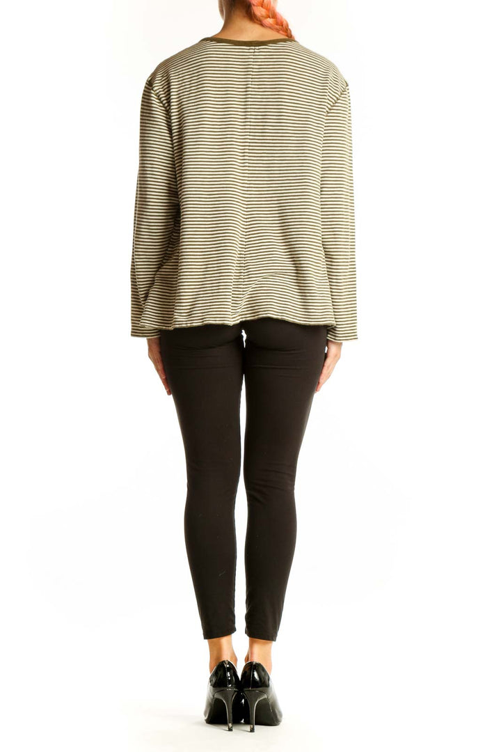 Side view of model wearing Banana Republic Olive Striped Long Sleeve Henley Top with black pants
