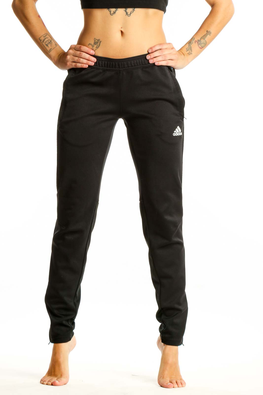 Front view of black Adidas athletic pants on woman