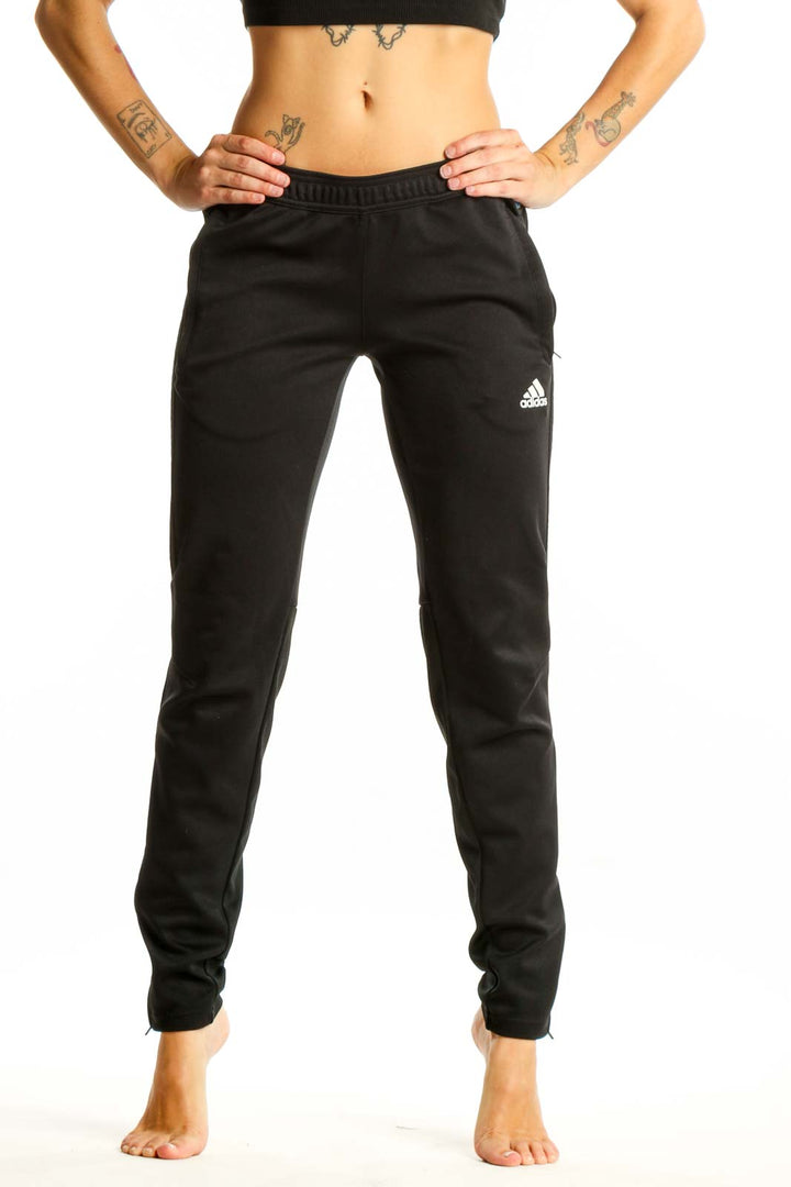 Front view of black Adidas athletic pants on woman