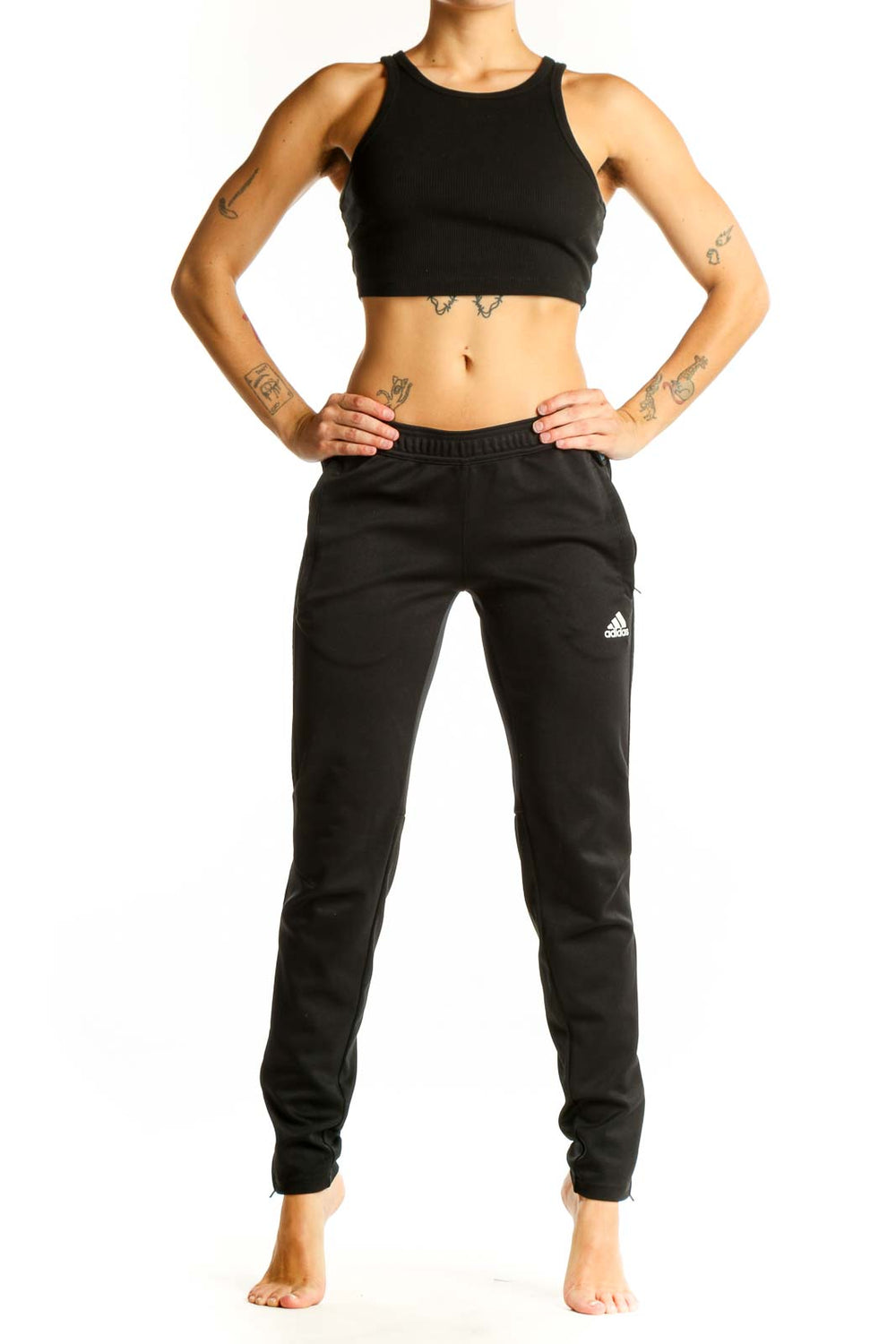 Front view of black Adidas athletic pants on woman
