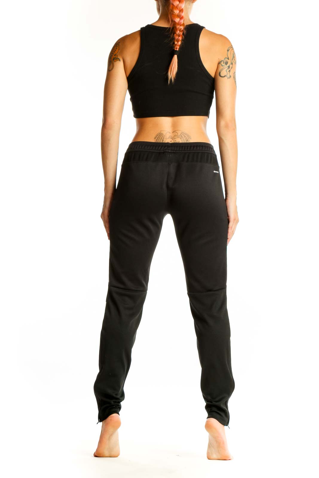 Side view of black Adidas athletic pants on woman