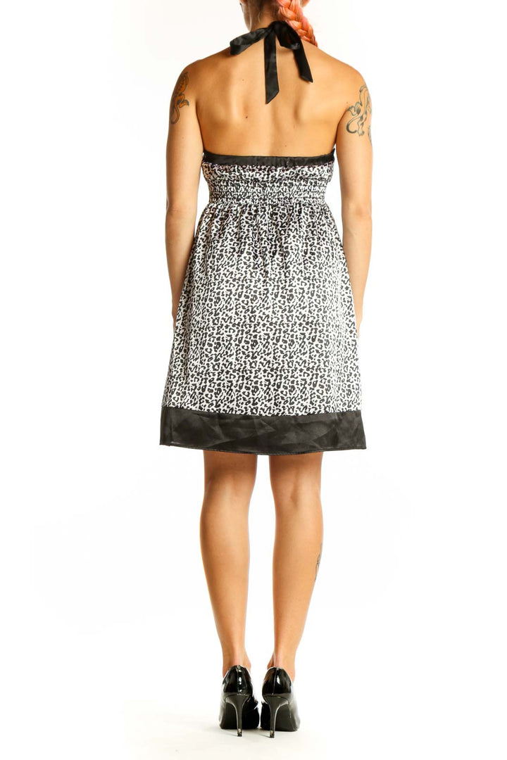 Side view of Guess Jeans black and white leopard print halter dress