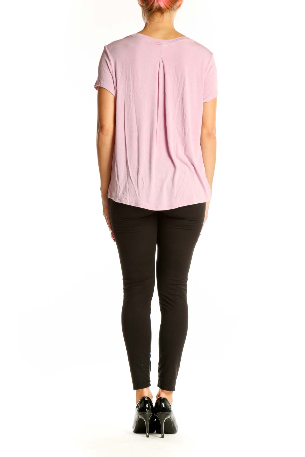 Side view of pink Athleta athletic top showing longer back hem