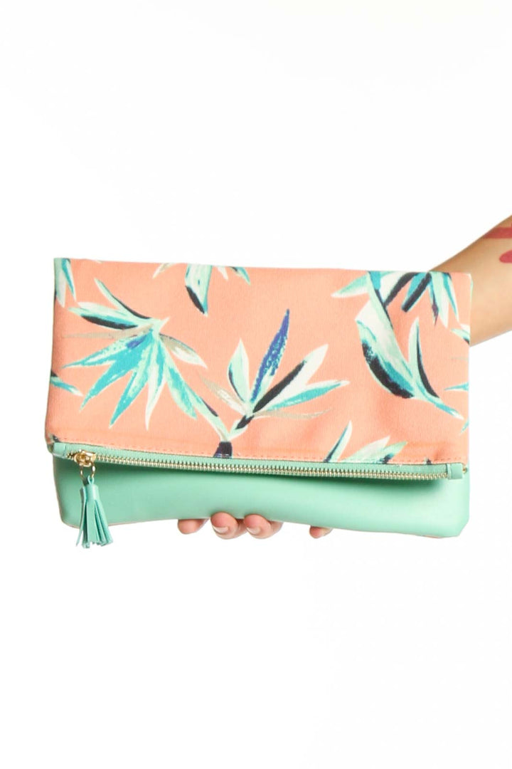 Front view of Rachel Pally peach floral print foldover clutch with mint green tassel