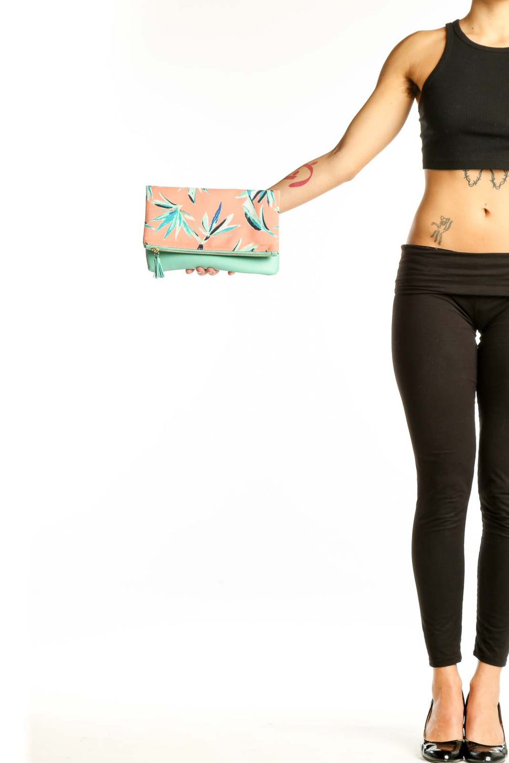 Front view of Rachel Pally peach floral print foldover clutch with mint green tassel