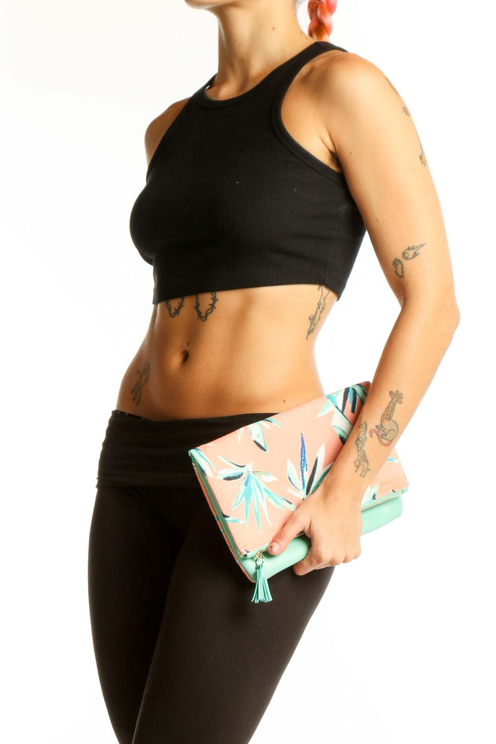 Front view of Rachel Pally peach floral print foldover clutch with mint green tassel