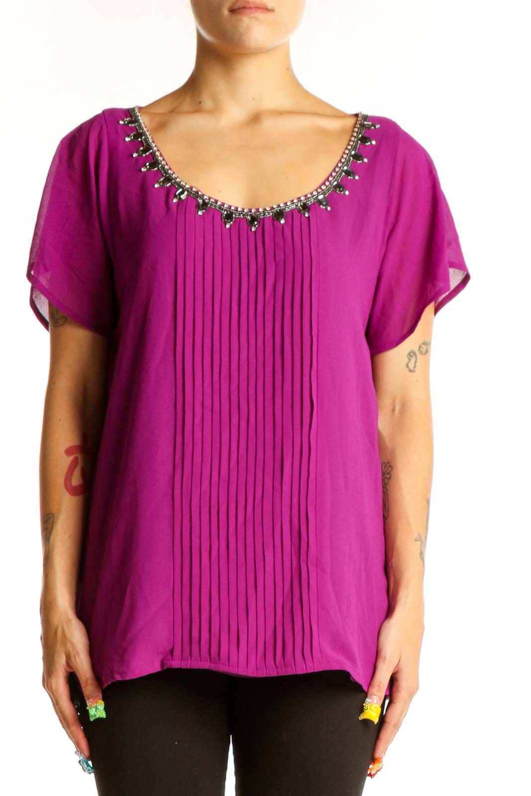 Front view of magenta pleated blouse with embellished neckline