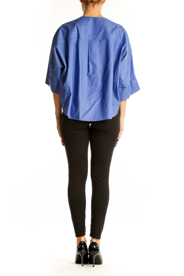 Side view of blue cotton kimono-style top showing relaxed fit and length