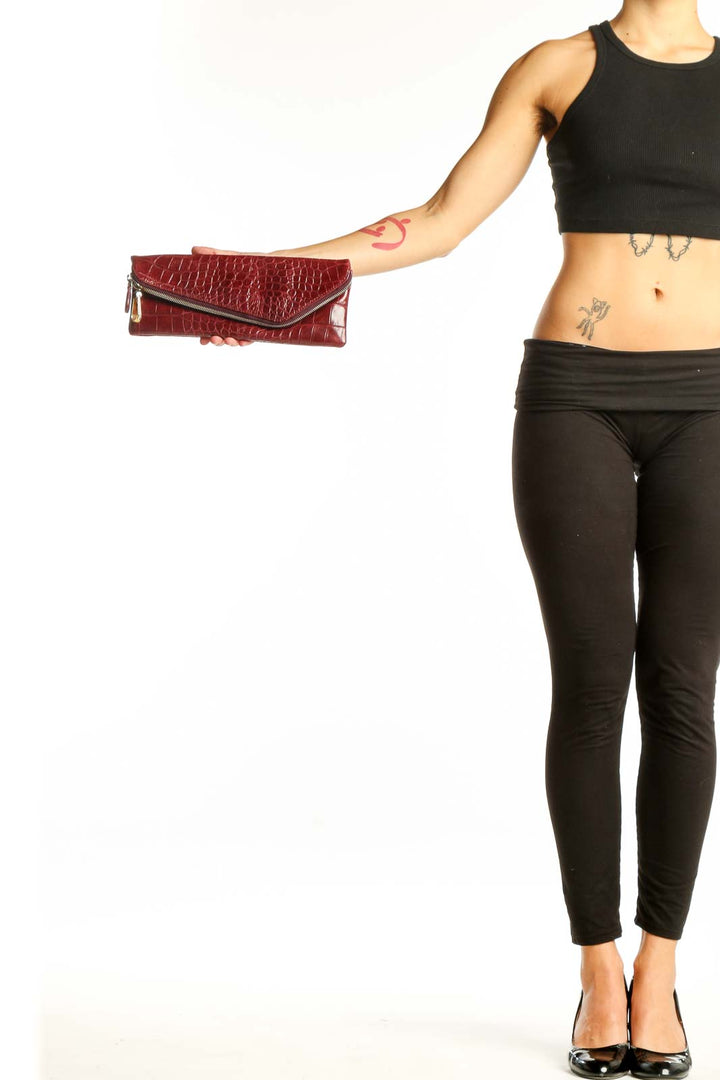 Front view of burgundy croc-embossed Henri Bendel envelope clutch with asymmetrical zipper