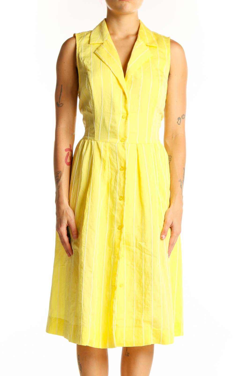 Front view of yellow striped sleeveless DKNY shirt dress with button-down front