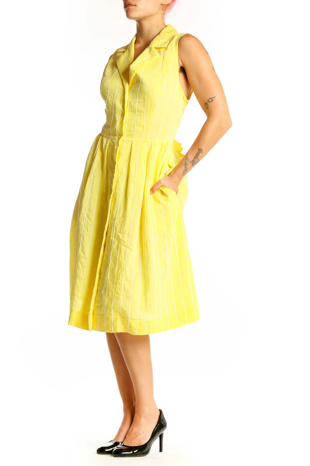 Front view of yellow striped sleeveless DKNY shirt dress with button-down front