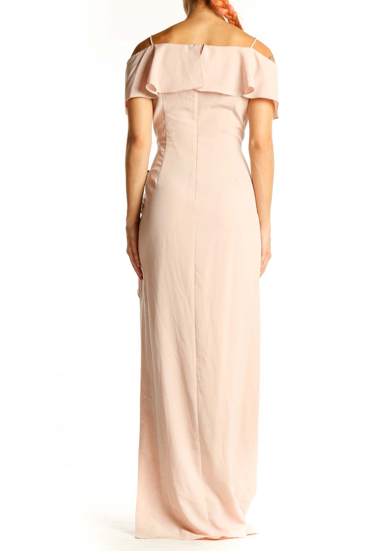 Side view of blush Adrianna Papell off-shoulder maxi dress showing ruffle and side slit
