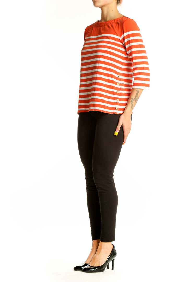 Front view of orange and white striped Maeve top with boat neckline